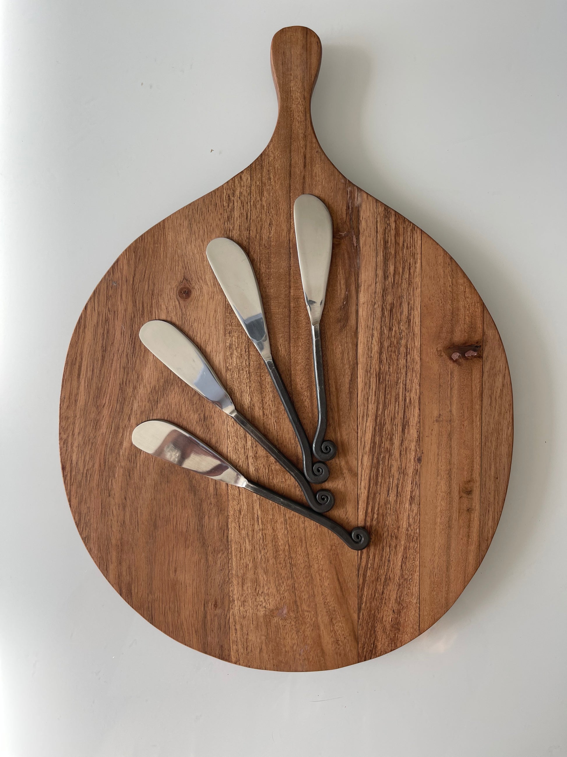 Board shown with Canape Knives. Dimensions 13-3/4"L x 9-3/4"W Acacia Wood Cheese/Cutting Board w/ Handle